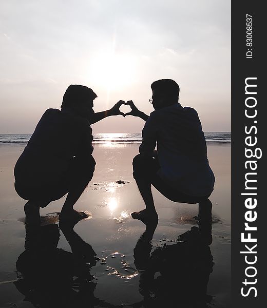 Silhouette of 2 Man Making Heart Sign