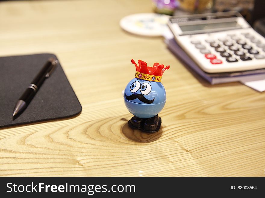 Blue Round Plastic Toy On A Desk