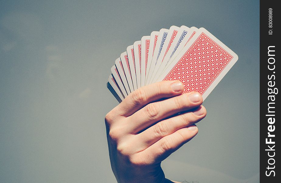 Close up of hand holding playing cards with copy space.