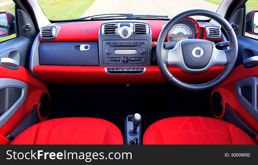 Interior of car with red seats and leather steering wheel. Interior of car with red seats and leather steering wheel.