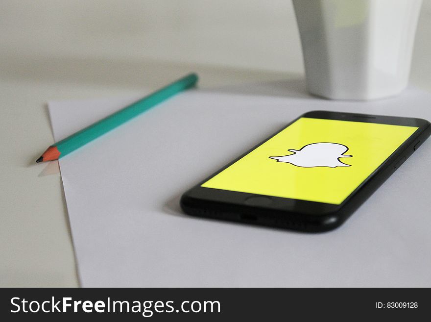 Smartphone on table running snapchat application. Smartphone on table running snapchat application.