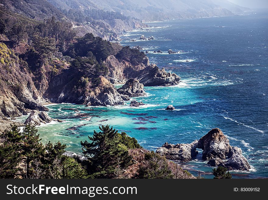 Rocky bay along coastline on sunny day.