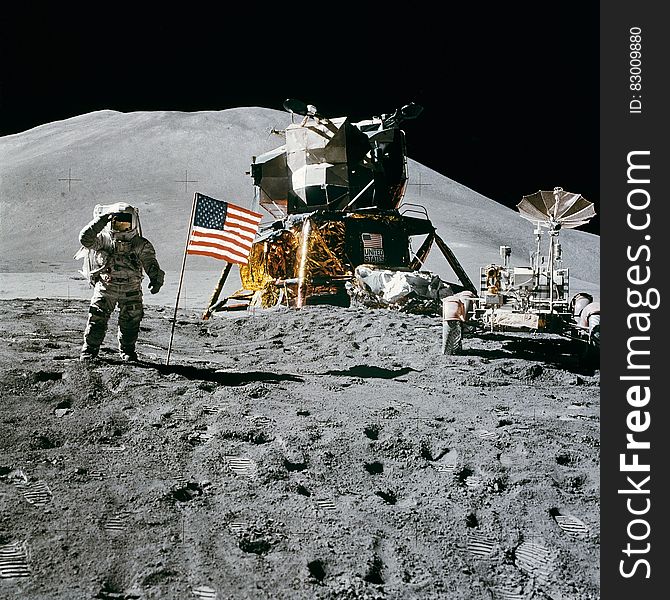 Astronaut Standing Beside American Flag on the Moon