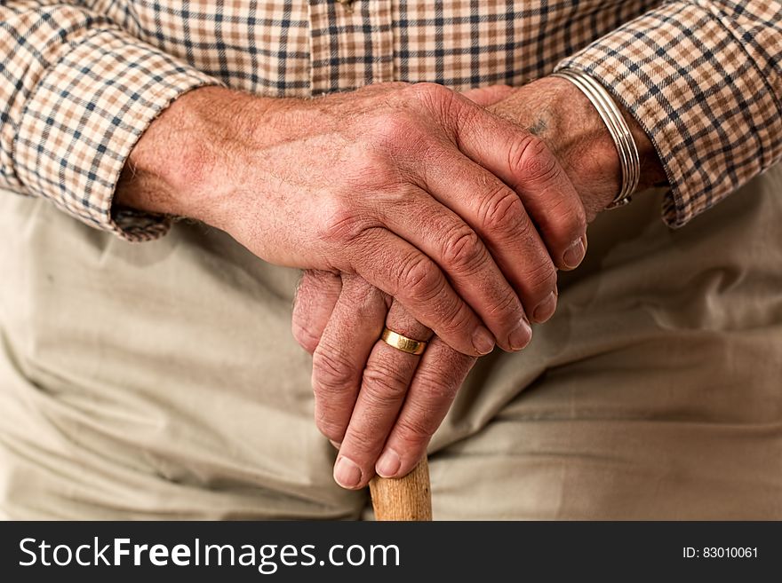 A close up an aged man leaning on cane. A close up an aged man leaning on cane.