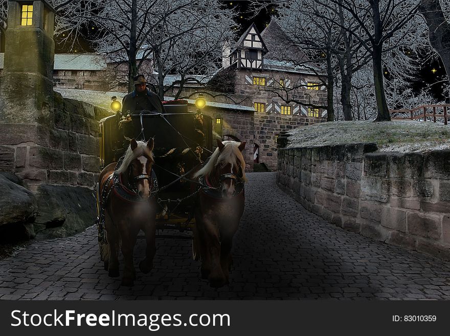 A horse-drawn coach on a cobblestone street. A horse-drawn coach on a cobblestone street.