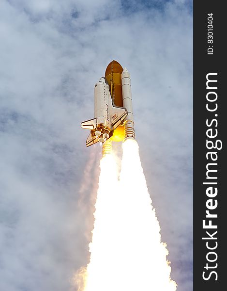 Launch of US Space Shuttle against blue skies and clouds. Launch of US Space Shuttle against blue skies and clouds.