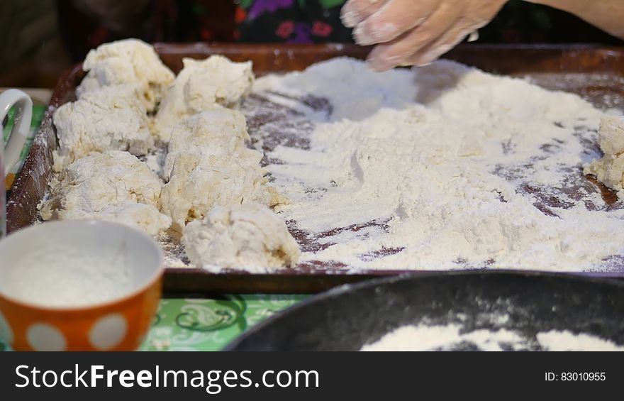 A family recipe, grandma`s hands knead the dough for buns