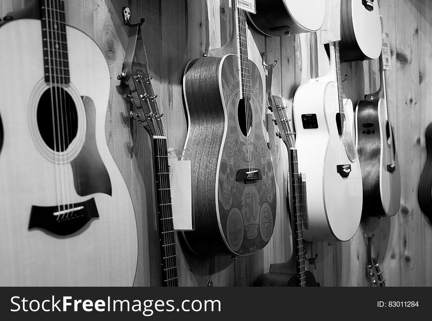 Gray Scale Photo of Acoustic Guitars