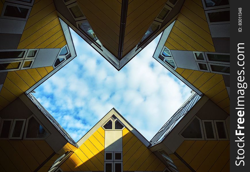 Low Angle Photo Of Yellow Wall Paint Building Under White Sky At Daytime