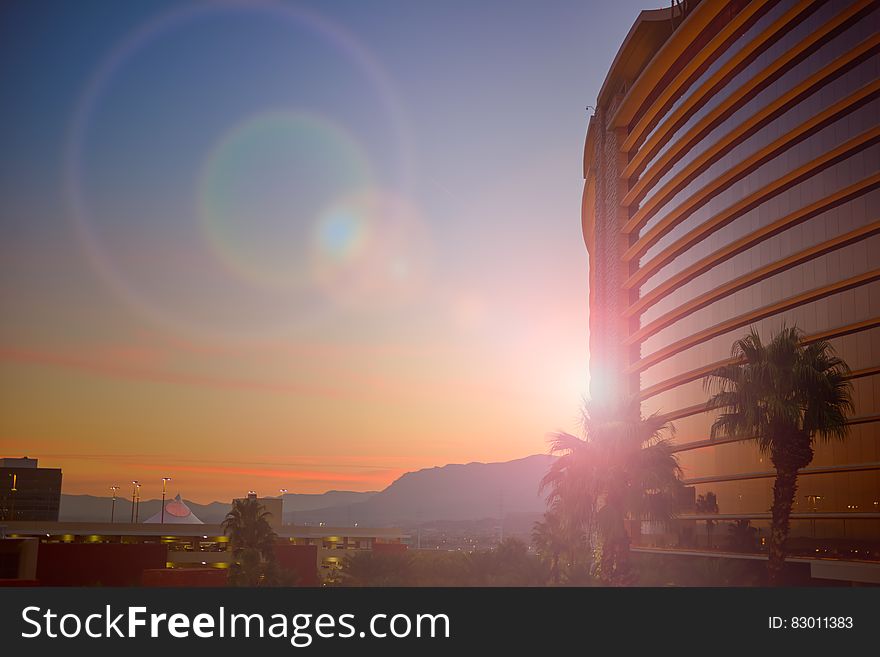 Sunset Behind Building With Palm Trees