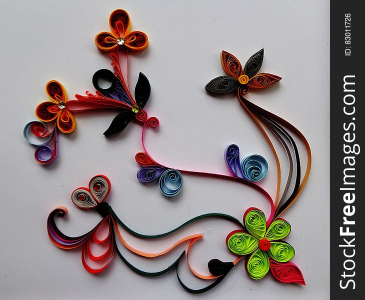 Close up of string art flowers on white.