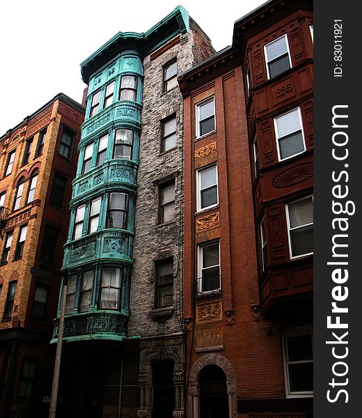 Colorful exterior of brick row houses against overcast skies. Colorful exterior of brick row houses against overcast skies.