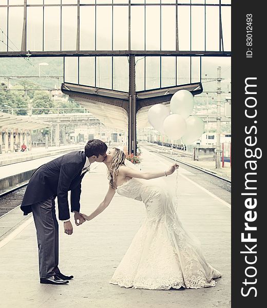 Couple Kissing Standing on the Train Waiting Platform