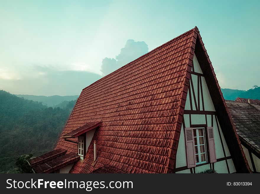 A tiled roof of a rustic style house. A tiled roof of a rustic style house.