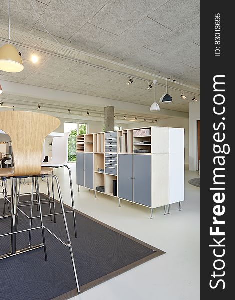 Table and bookshelves inside modern apartment. Table and bookshelves inside modern apartment.