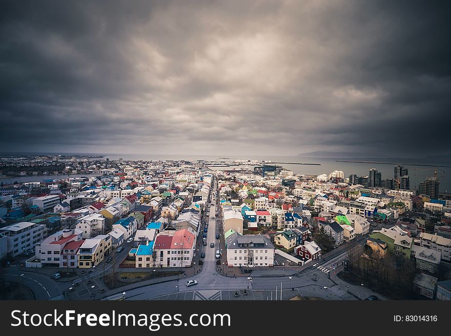 Aerial view over roof tops of Iceland waterfront village with stormy grey skies. Aerial view over roof tops of Iceland waterfront village with stormy grey skies.