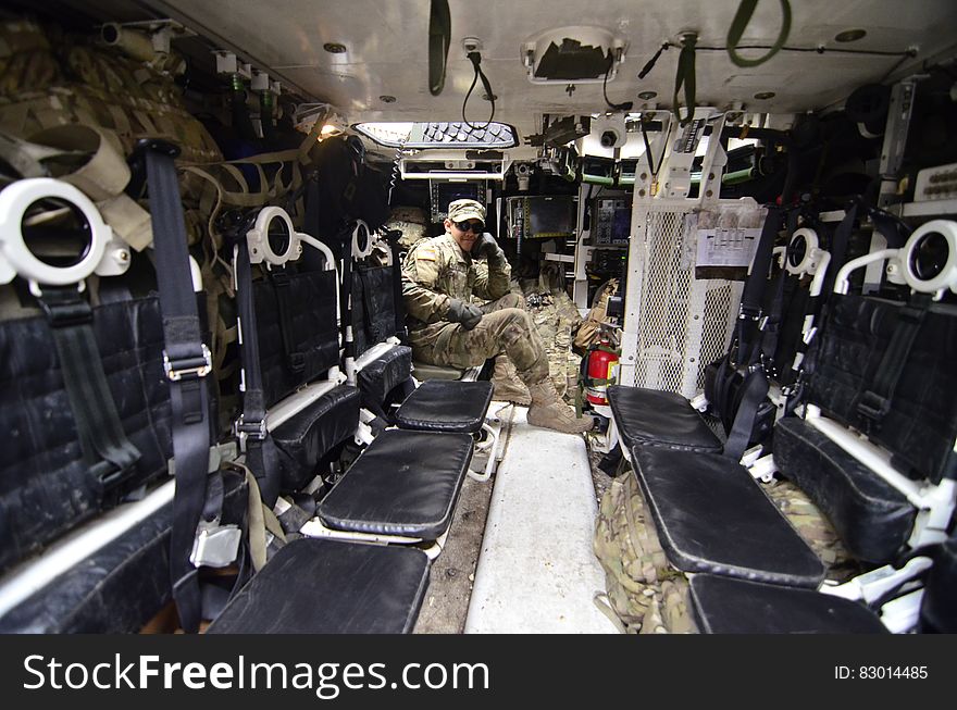 Man in Soldier Suit Sitting in Black Leather Seat