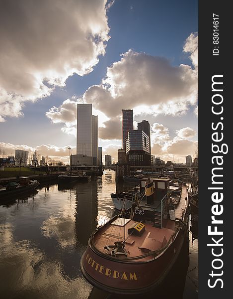 Boat on waterfront of Rotterdam, Netherlands with skyline against blue skies. Boat on waterfront of Rotterdam, Netherlands with skyline against blue skies.