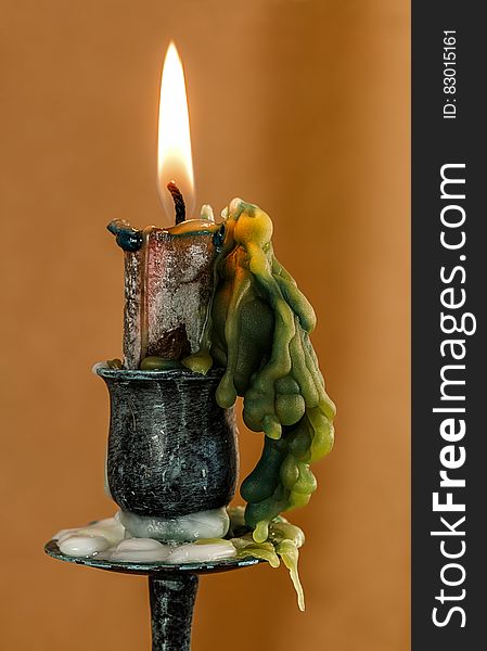 Close up of wick burning in wax candle on candlestick. Close up of wick burning in wax candle on candlestick.