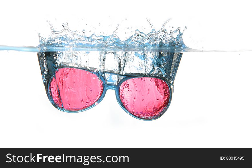 Black Framed Red Aviator Sunglasses on Water
