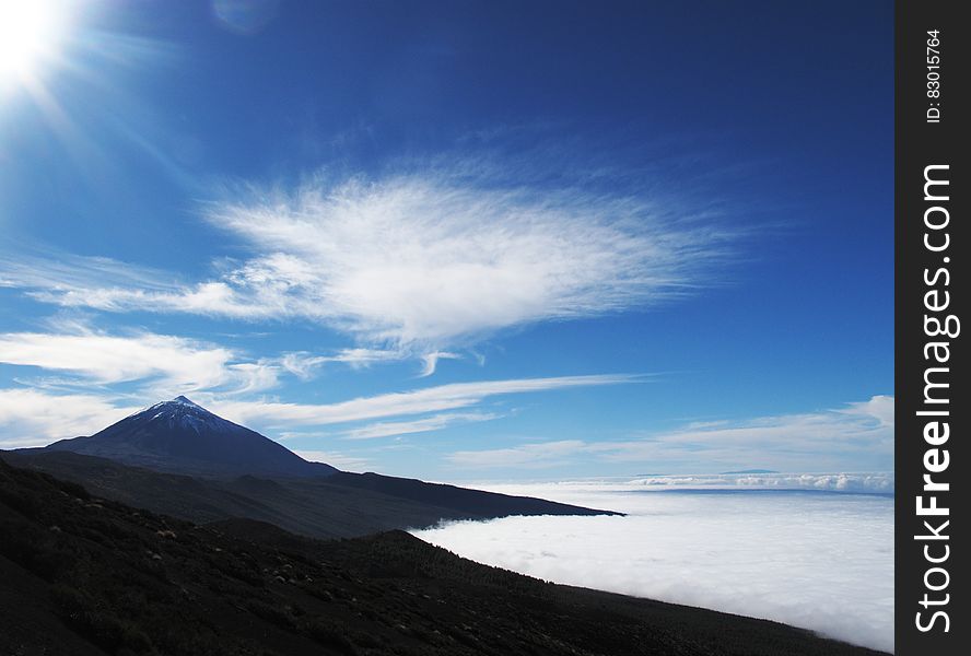 Brown Concrete Mountain Under Blue And White Sky During Dayitme