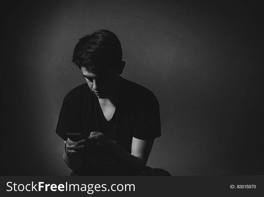 Portrait of man using smartphone in black and white studio portrait. Portrait of man using smartphone in black and white studio portrait.