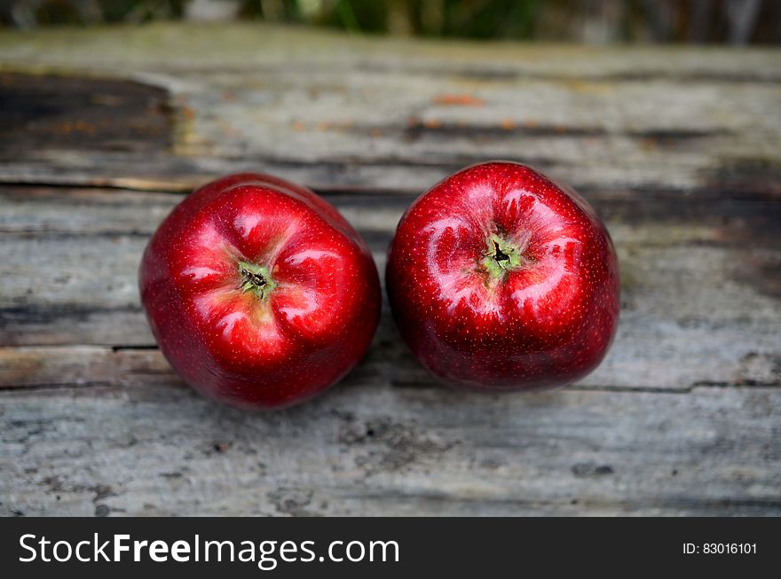 Close up of two red apples on worn wooden plank. Close up of two red apples on worn wooden plank.