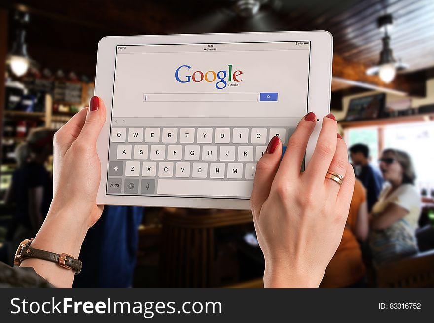 Person Holding White Ipad