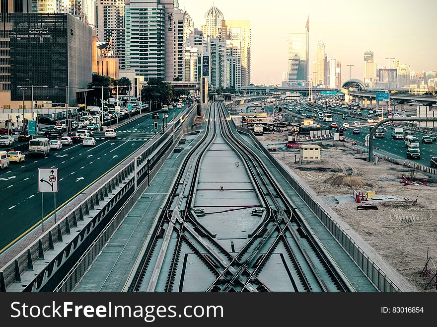 Traffic on roadway with public transportation track in Dubai, UAE on sunny day. Traffic on roadway with public transportation track in Dubai, UAE on sunny day.