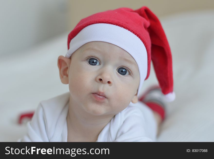 Portrait of young baby wearing red Santa stocking cap. Portrait of young baby wearing red Santa stocking cap.