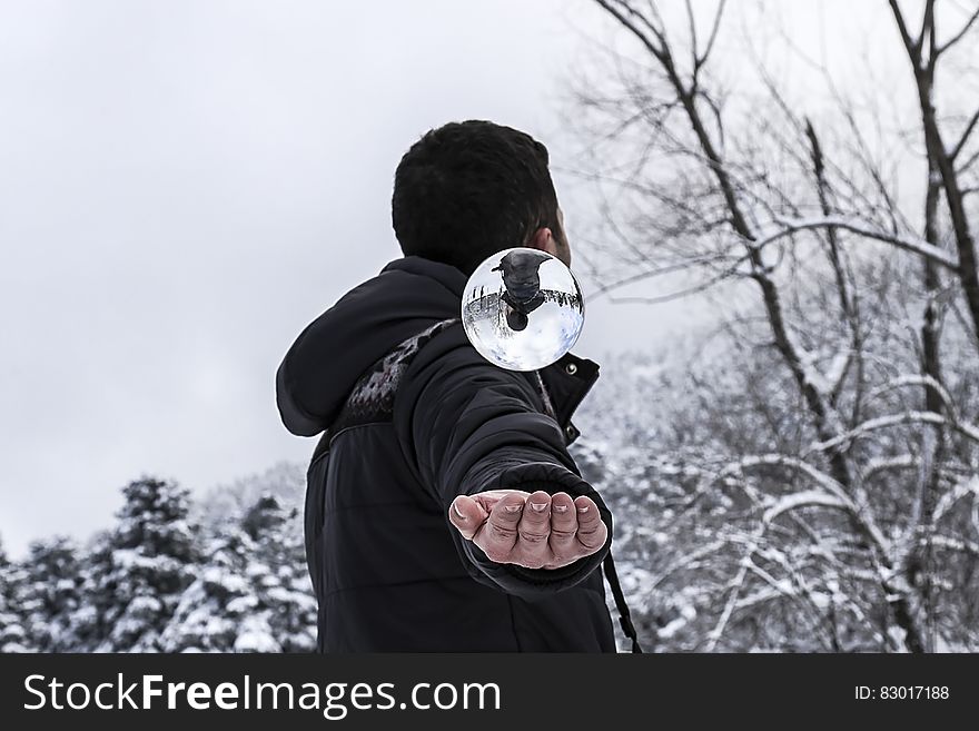 Man in Black Hoodie during Snow Weather at Daytime