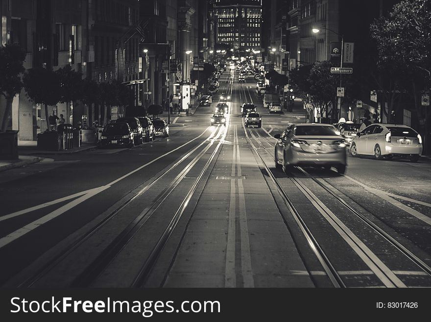 Trolley tracks down streets of San Francisco, California at night.