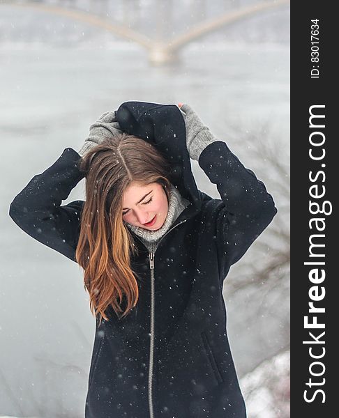 Woman Grabbing the Hood of Her Hoodie