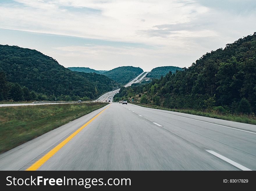 A scenic country highway on a cloudy day.