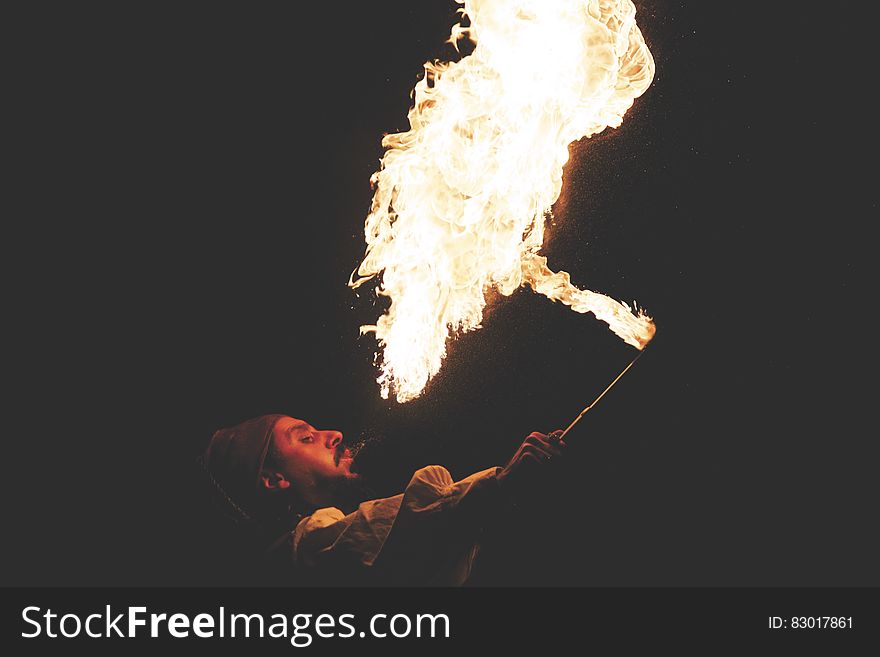 Man Blowing Fire During Nighttime