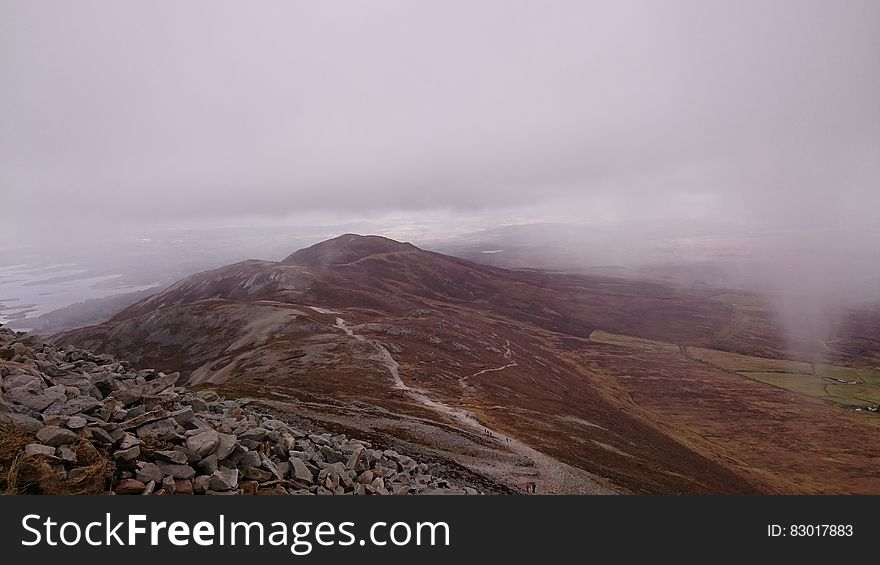 Fog over rocky crags in mountain landscape. Fog over rocky crags in mountain landscape.