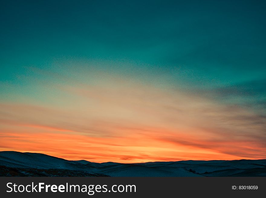 Sunset over Snow Covered Mountains