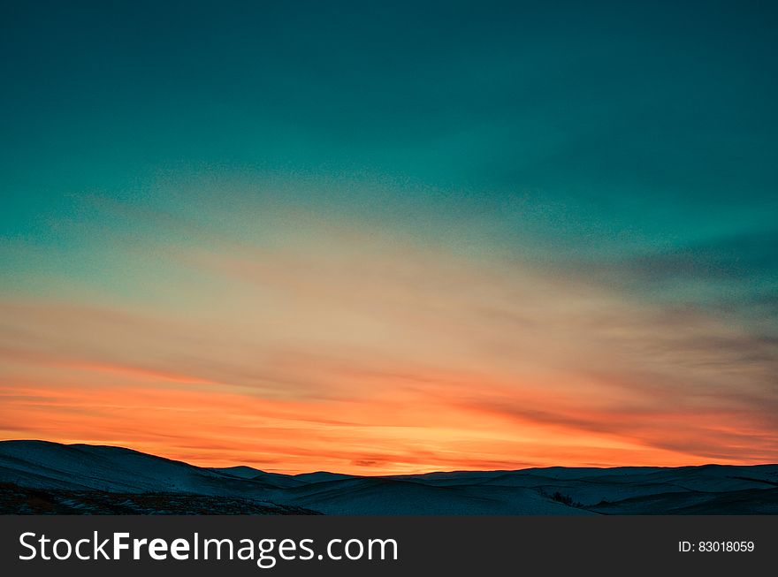 Sunset Over Snow Covered Mountains