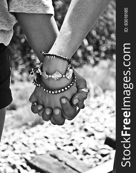 Greyscale Photography of Two Person Holding Hands
