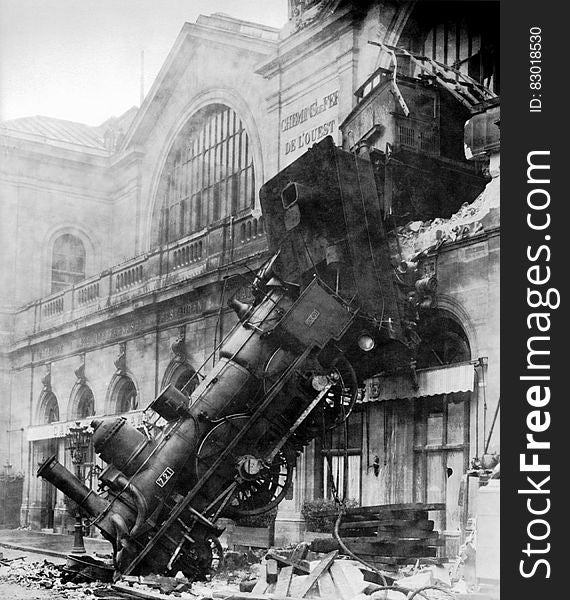 Locomotive engine through walls of train station in Montparnasse, Paris, France in 1895 in black and white. Locomotive engine through walls of train station in Montparnasse, Paris, France in 1895 in black and white.