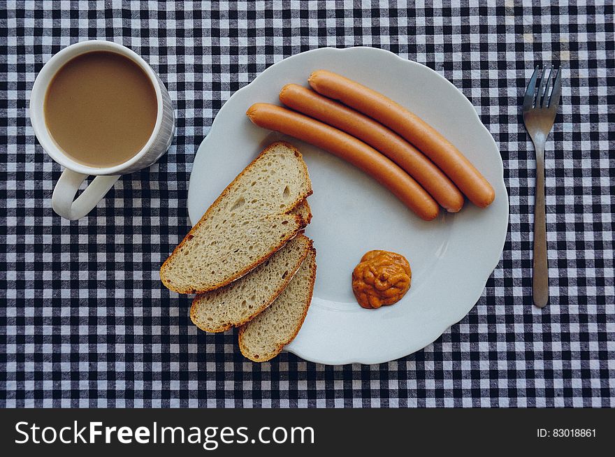 Sausages, Bread and Coffee on Table