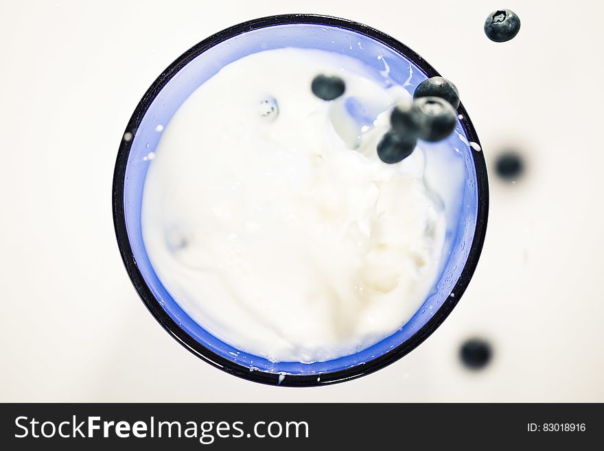 Blueberries Splashing In Milk