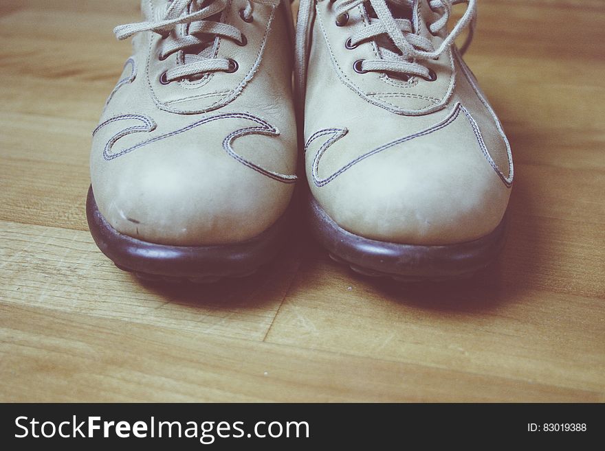 Close up of leather shoes on wooden floor.