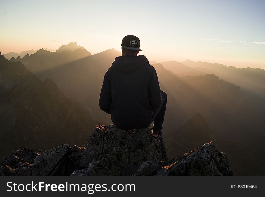Man Sitting on the Mountain Edge
