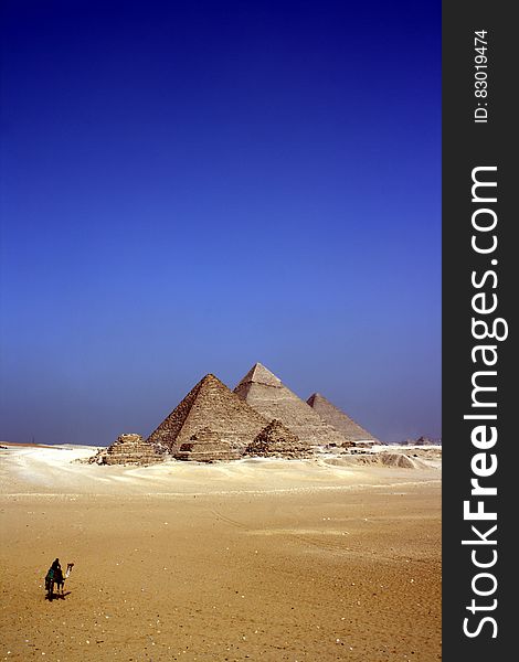 Grey Concrete Pyramids on the Middle of the Dessert during Daytime