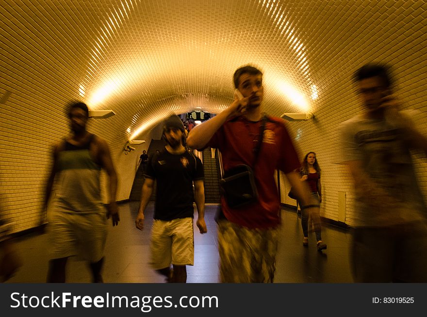 People walking along an underground passage in the subway. People walking along an underground passage in the subway.