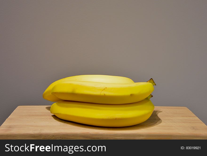 Yellow Bananas on an Oak Wood Table