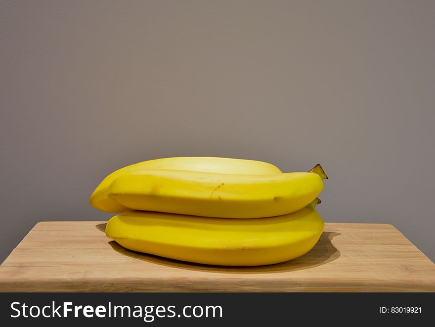 Yellow Bananas On An Oak Wood Table