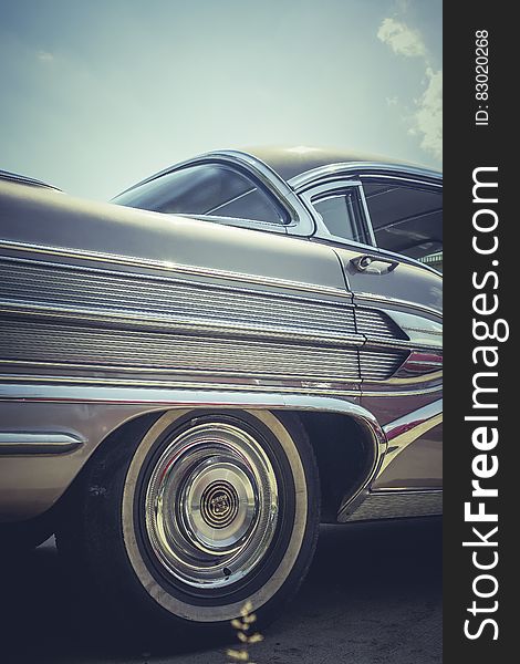 A close up of the rear wheel of a classic car.