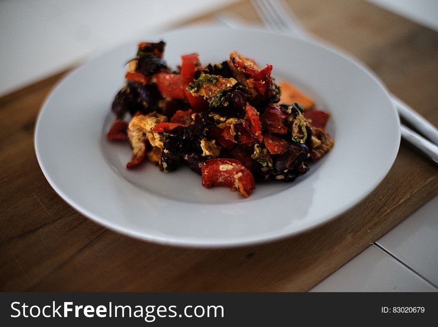 Black and Red Dish on White Plate